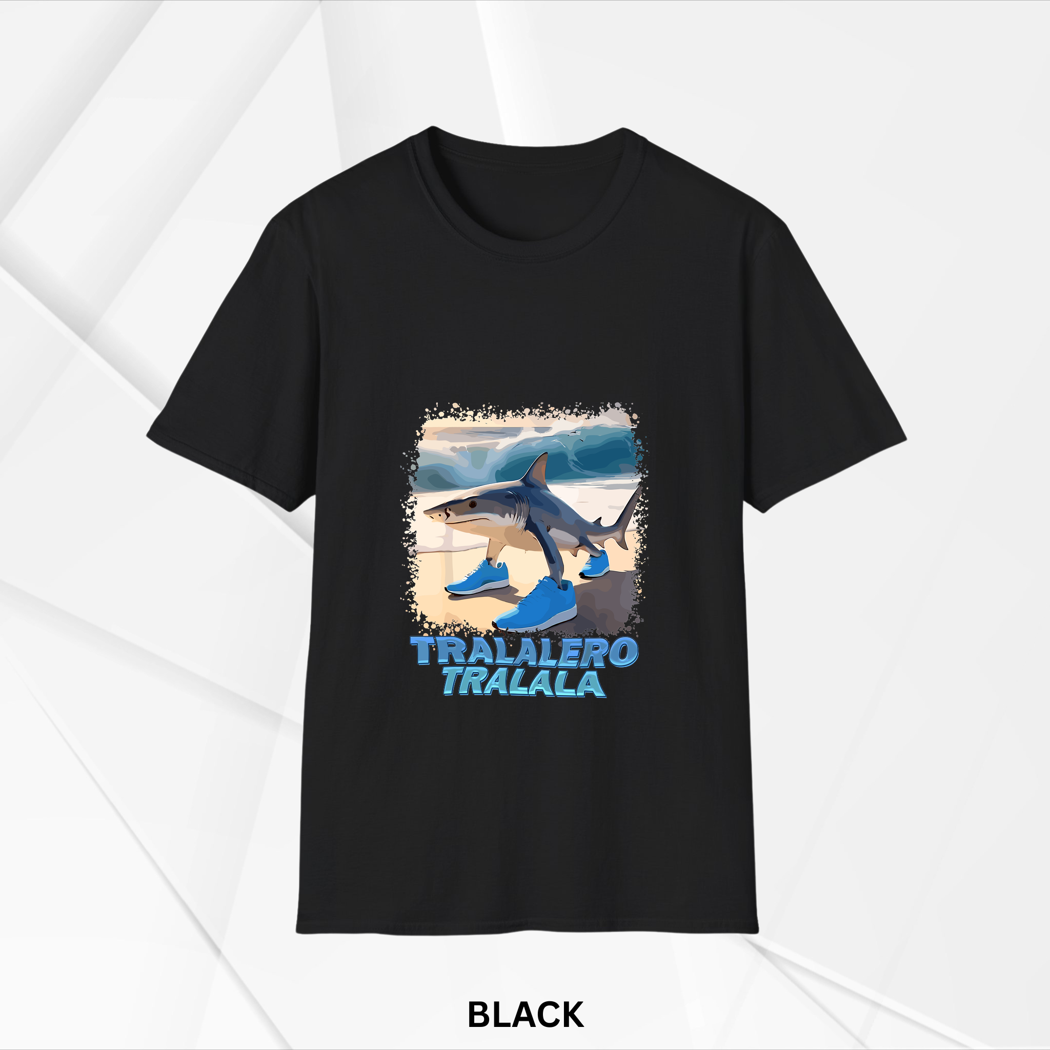 Black t-shirt featuring a colorful graphic of a shark wearing bright blue sneakers with the text 'TRALALERO TRALALA' underneath on a beach background